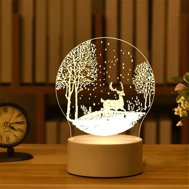 A glowing acrylic night light shaped like a forest silhouette sits on a wooden table.