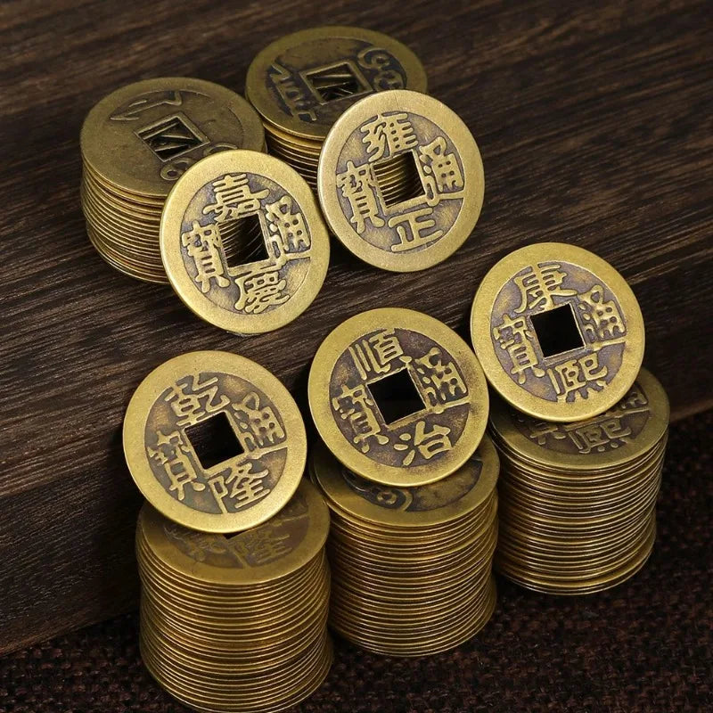 A stack of antique Chinese Feng Shui coins made of gold or brass, featuring traditional characters for wealth and good fortun