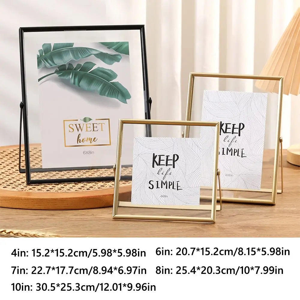 A set of modern metal and acrylic photo frames in gold and black finishes displayed on a wooden surface.