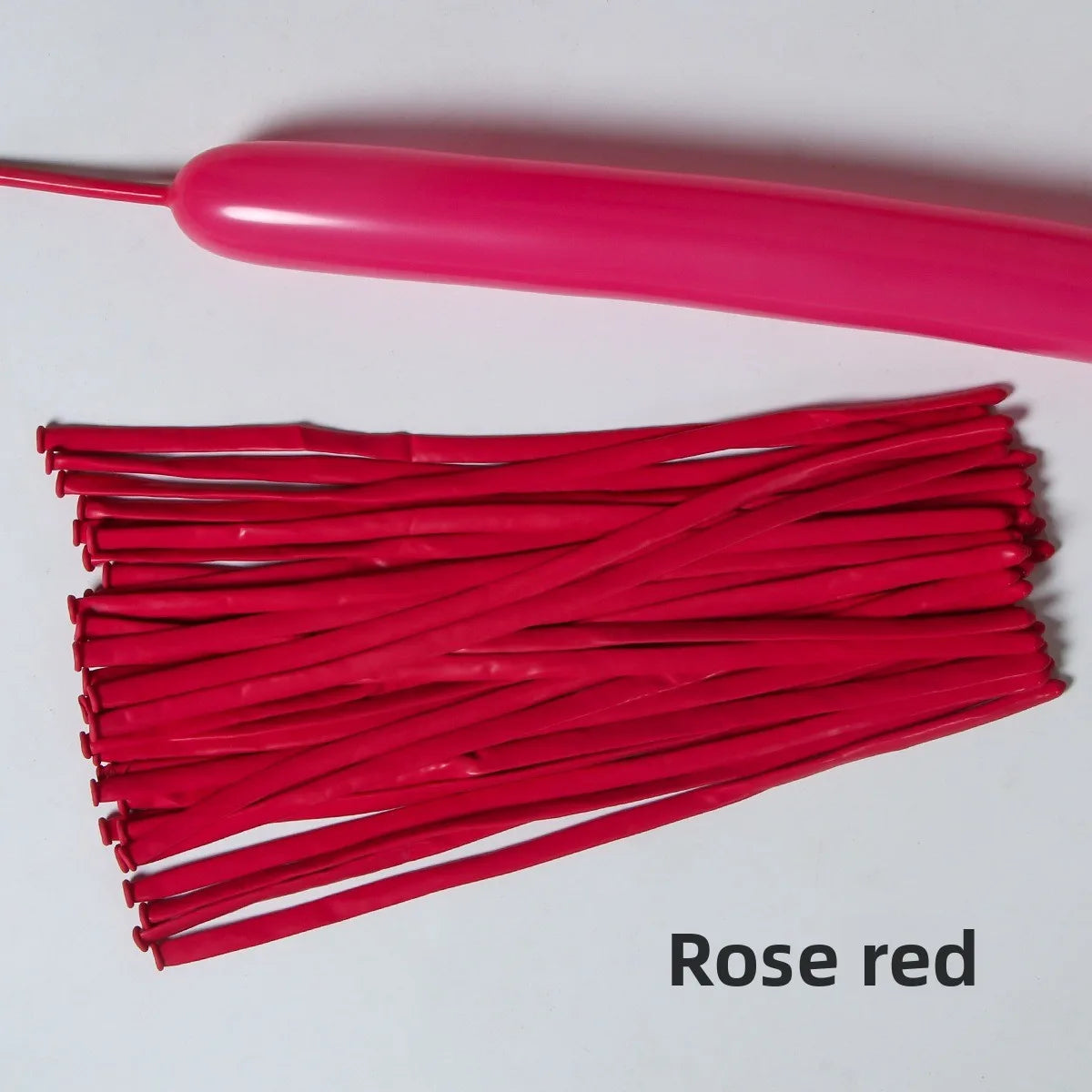 A bundle of rose red latex strip balloons and a pink balloon stick.