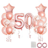 A collection of rose gold foil balloons including star shapes and numbers for a 50th birthday party decor