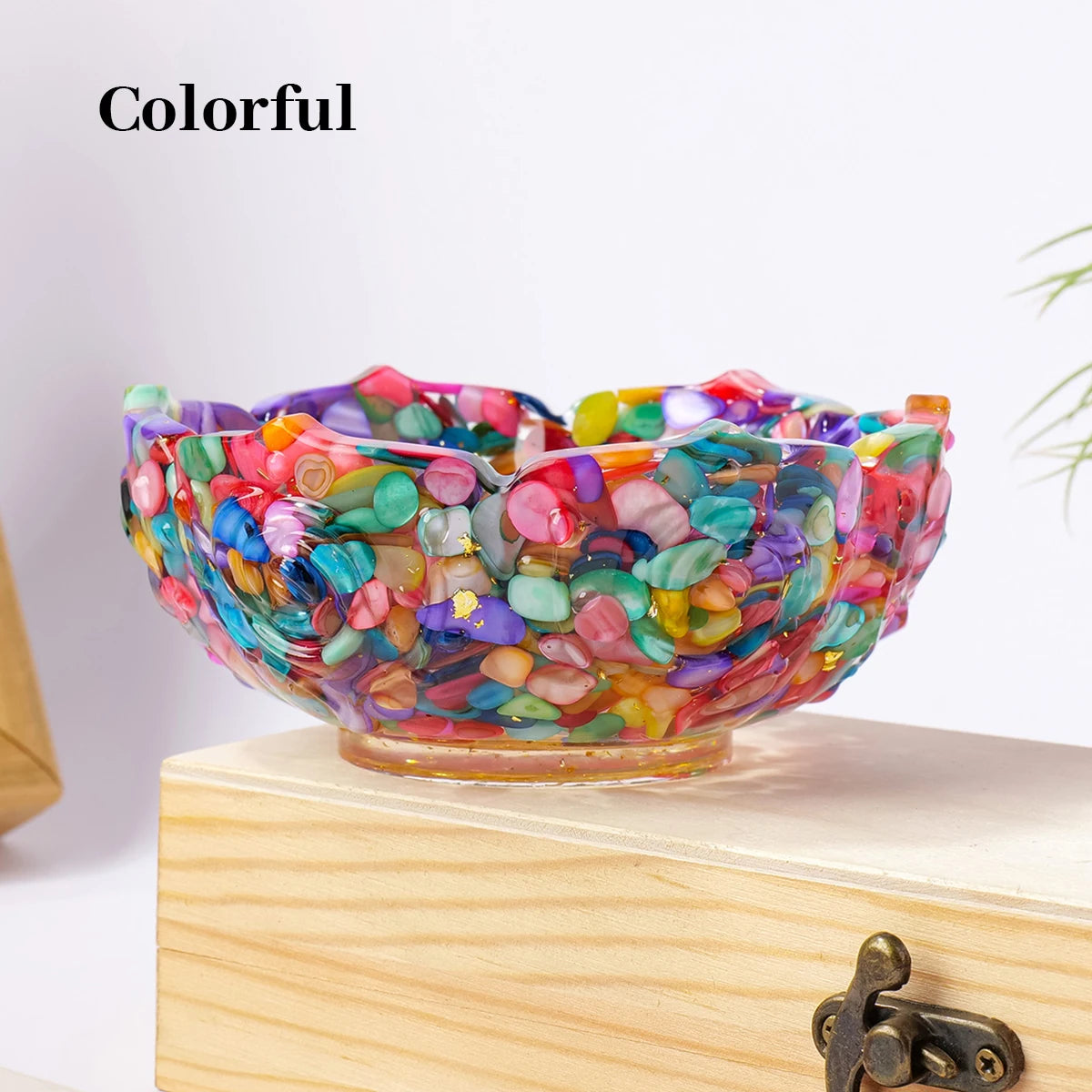 Colorful natural crystal lotus bowl filled with various colored stones on a wooden surface