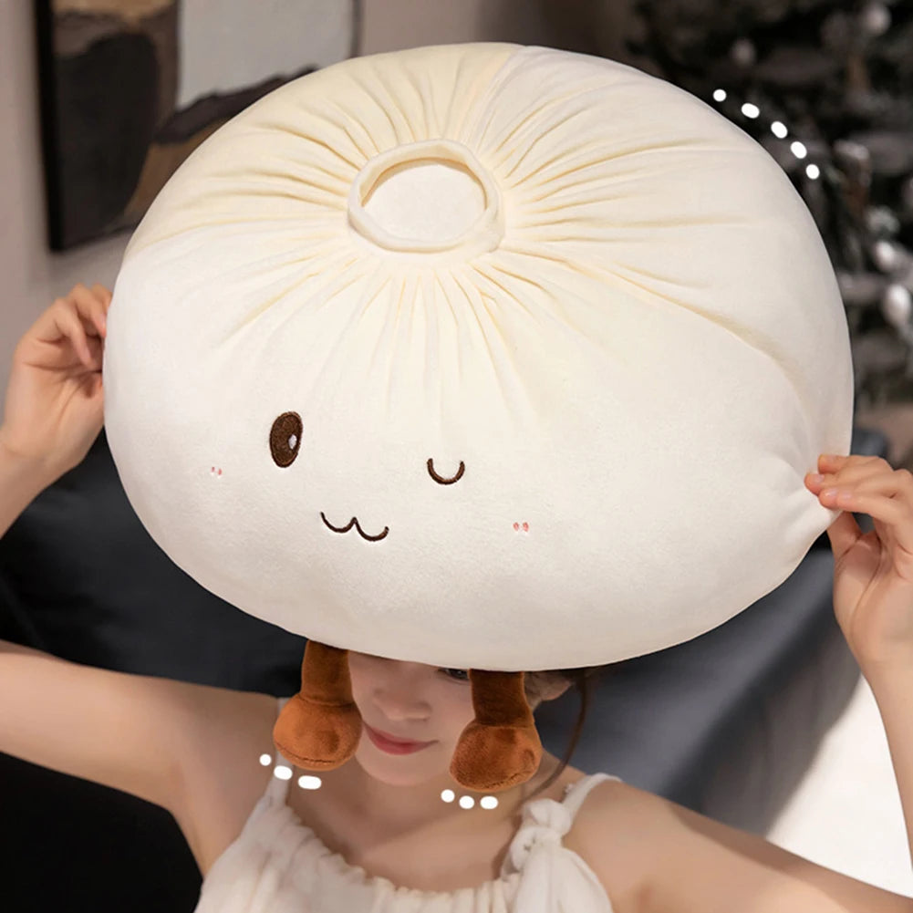 A woman is holding a large, round, cream-colored dumpling plush pillow with brown ears.