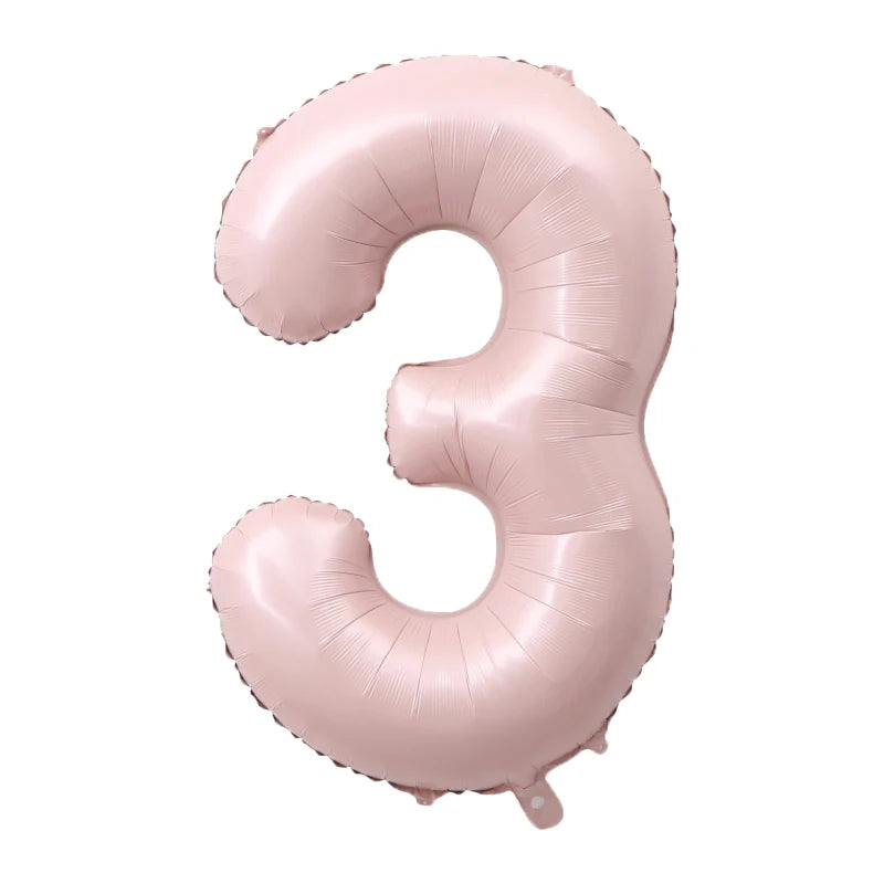 A pink foil number balloon shaped like the number three.