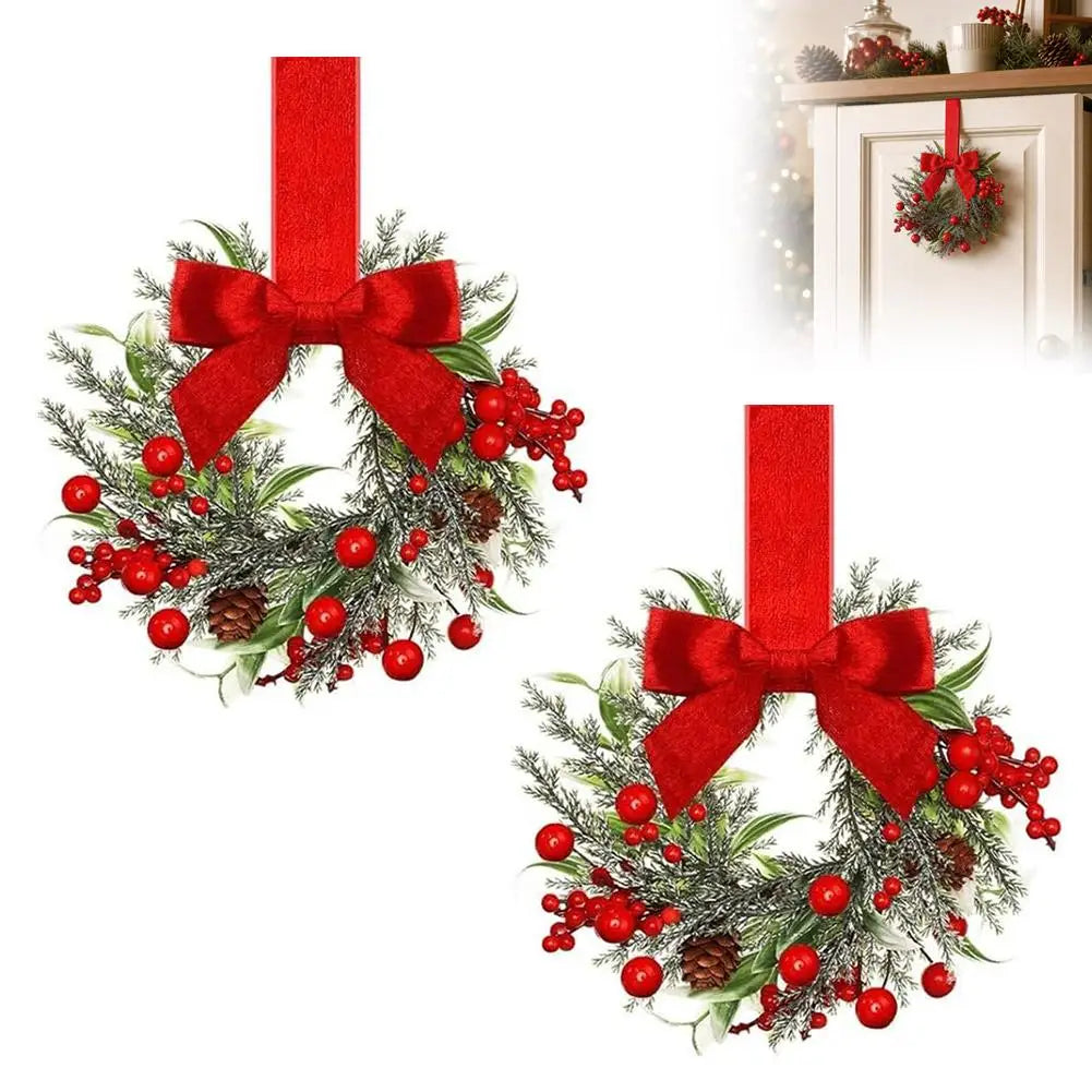 A 10-inch artificial Christmas wreath decorated with green foliage, red berries, and a large red velvet bow.