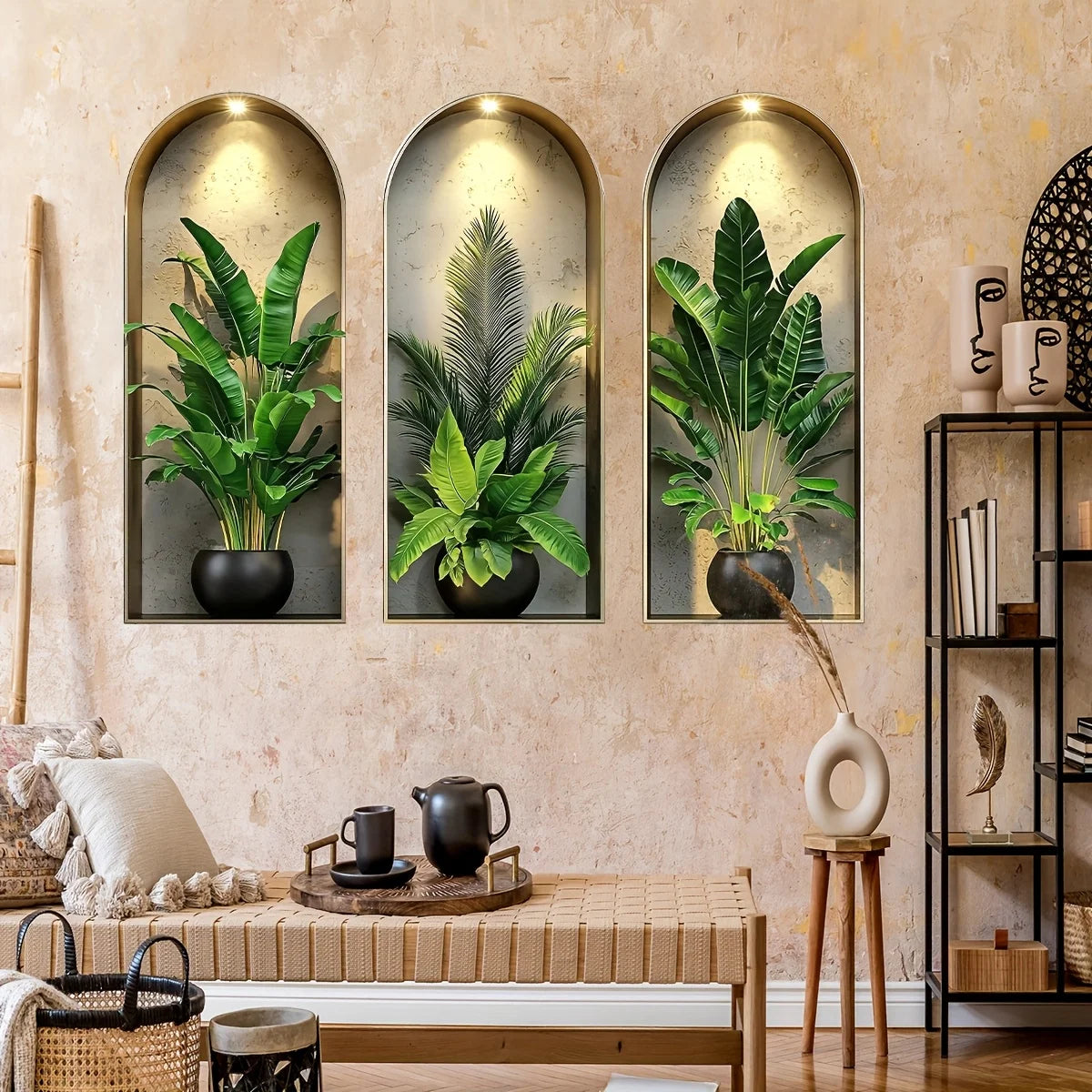 Three framed watercolor stickers of potted green plants and vines on a beige wall.