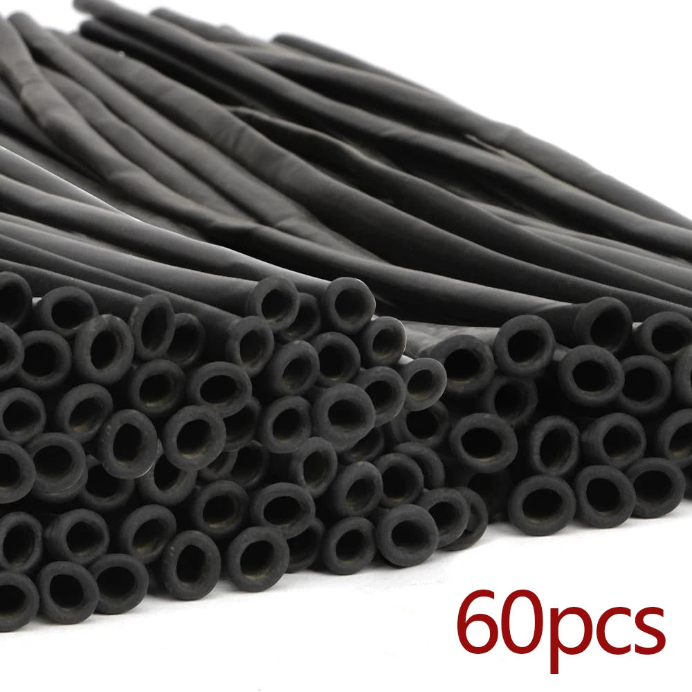 A pile of matte black latex balloons for party decorations and balloon artistry.