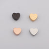 Three heart-shaped stainless steel bead charms in black, gold, and silver.