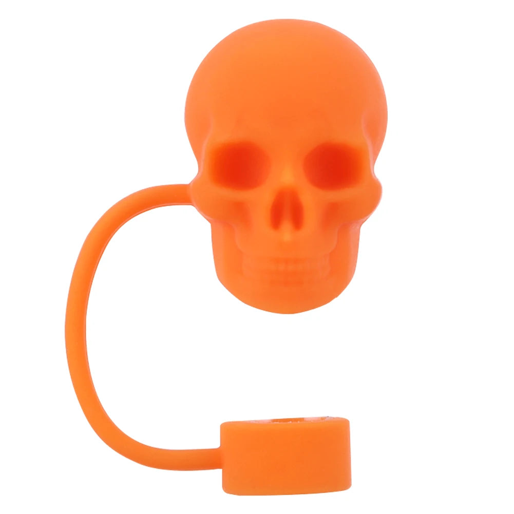 An orange reusable silicone straw cover shaped like a skull with a flexible loop.