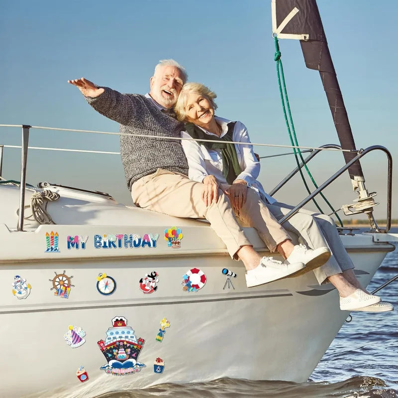 An elderly couple smiling while sitting on a boat with various nautical magnets displayed on the hull.