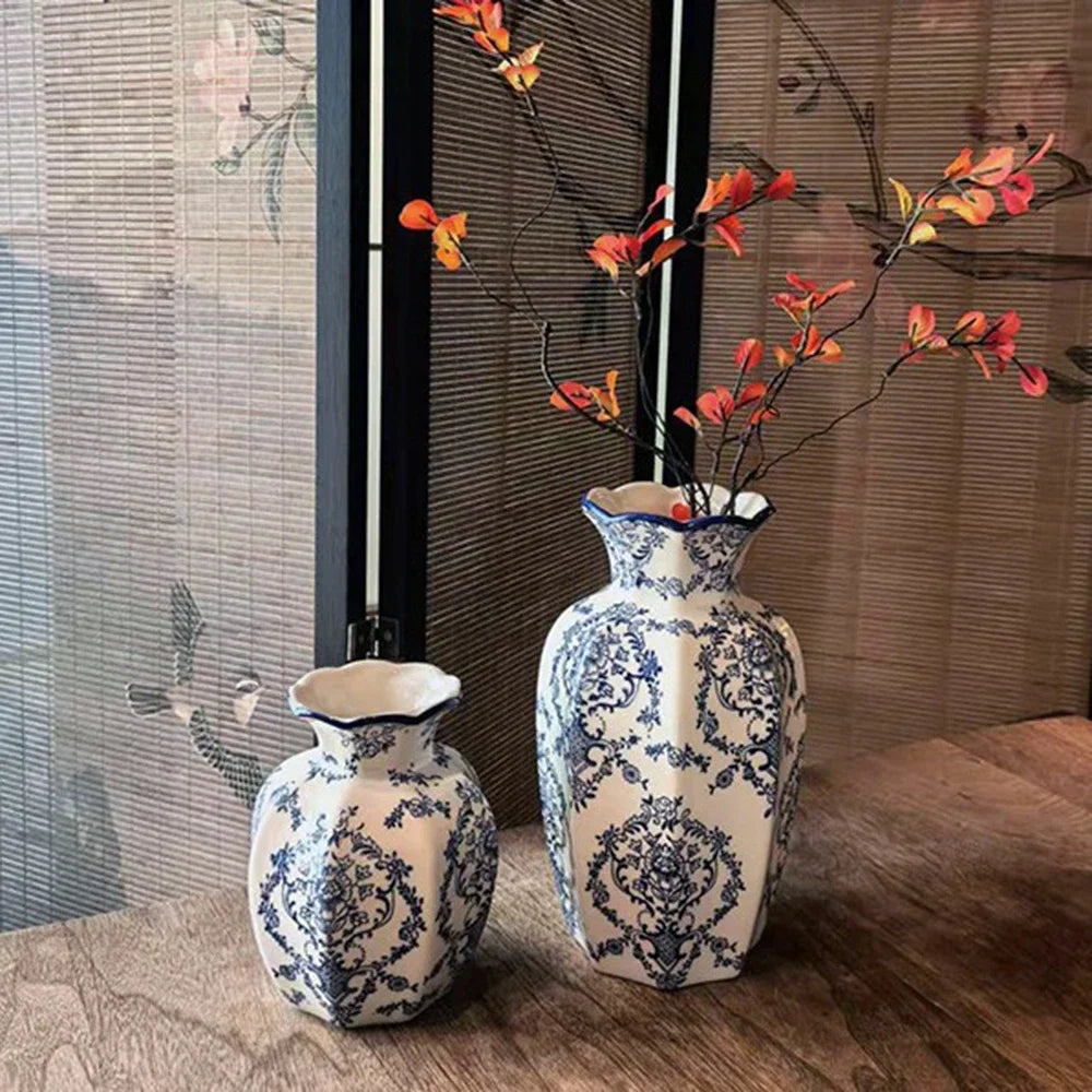 A pair of hand-painted blue and white porcelain vases displayed on a wooden surface.