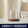 Clear glass aromatherapy candle holder with a decorative top and a wooden base.