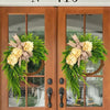 Rustic hydrangea wreath with a bow decorating a wooden door and glass panel.