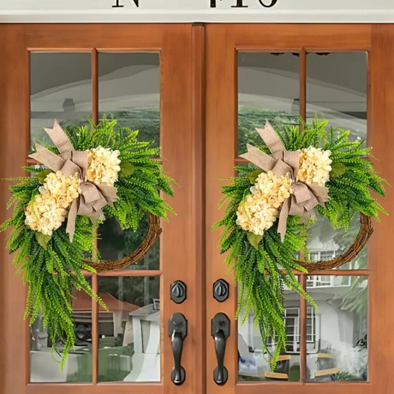 Rustic hydrangea wreath with a bow decorating a wooden door and glass panel.