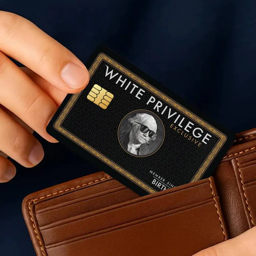 A hand holds a black credit card with gold accents and text, resting on a brown leather wallet.