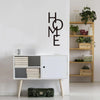 Black metal word art decor spelling out HOME mounted on a white wall