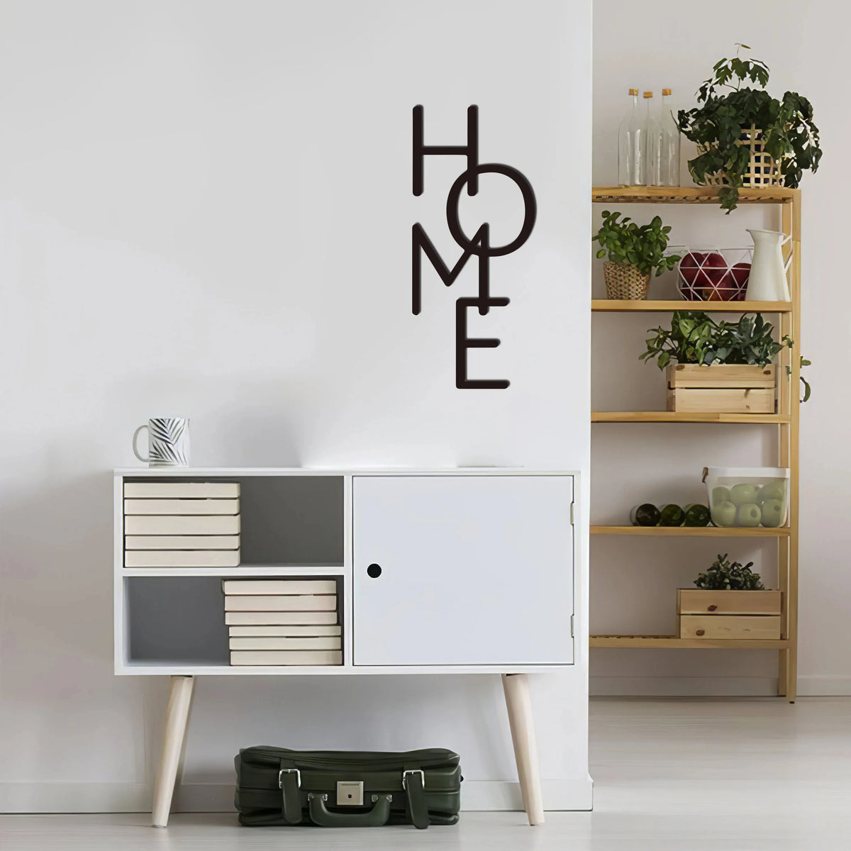 Black metal word art decor spelling out HOME mounted on a white wall