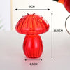 A bright red, translucent glass vase shaped like a mushroom, shown with dimensions.
