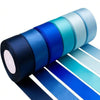 A roll of satin silk ribbon in various shades of blue and teal, shown next to a flat display.