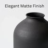 A close-up of a large matte black decorative vase with an elegant finish.
