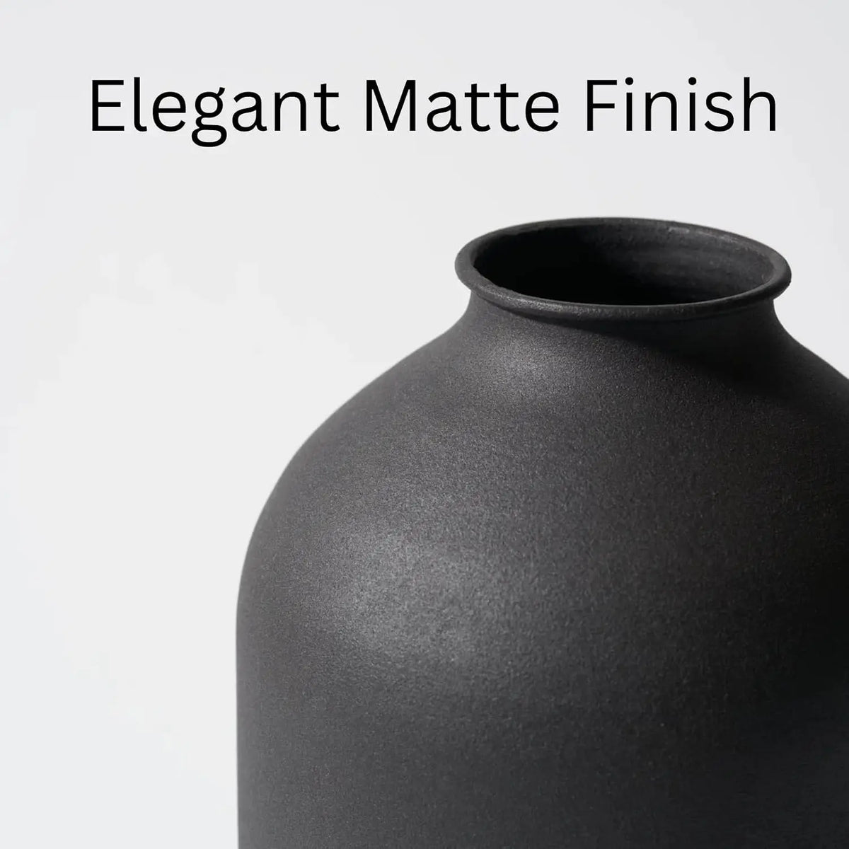 A close-up of a large matte black decorative vase with an elegant finish.