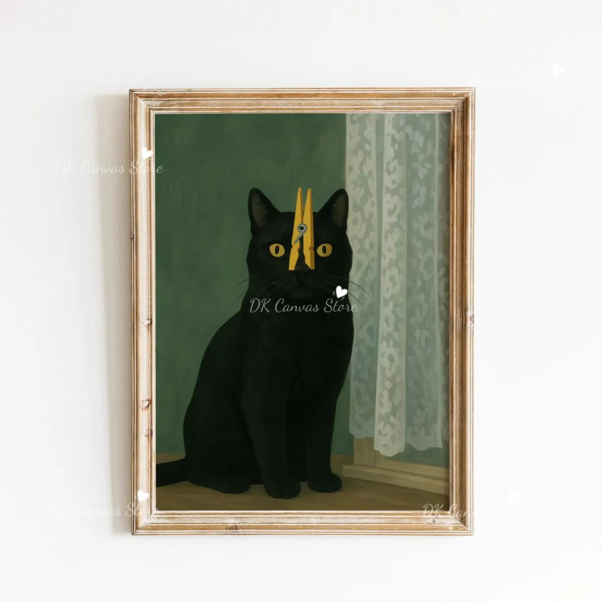 A framed canvas art print featuring a black cat with yellow eyes sitting in a green and cream patterned room.
