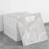 A stack of white self-adhesive marble tile stickers on a gray floor.