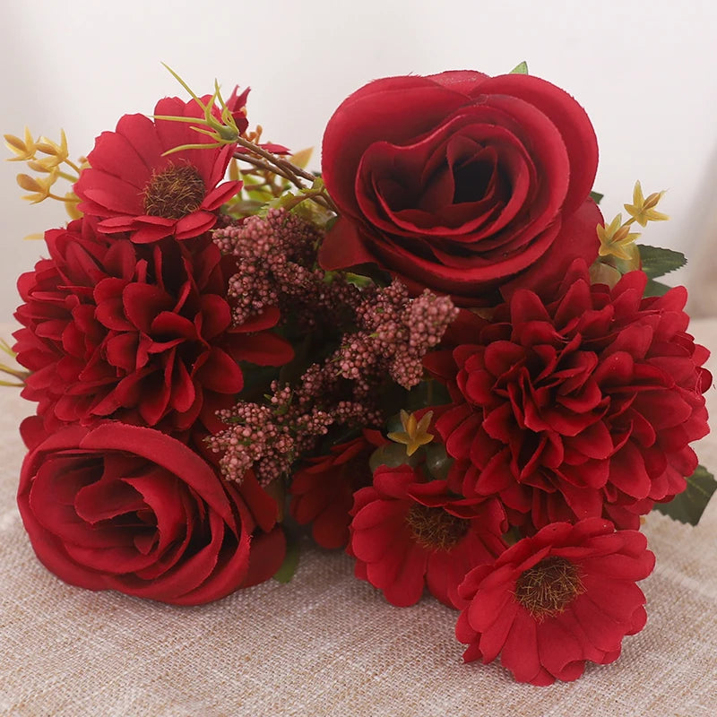 A bouquet of deep red silk roses and hydrangea flowers.