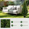 A modern outdoor sofa set placed in a garden setting with an artificial cedar topiary tree nearby.