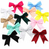 A collection of colorful satin ribbon bows in pink, blue, yellow, green, and black, arranged against a white background.