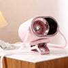A pink clip-on mini electric fan with a clear grille and power switch is displayed on a white marble surface.