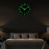 A green glow-in-the-dark wall clock is mounted above a dark bed, showing the time as 12:00.