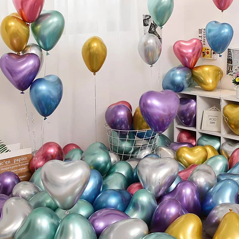 A collection of heart-shaped latex balloons in various shades of pink, blue, green, and gold are displayed on a shelf.