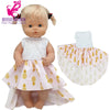 A 40cm doll outfit set featuring a blonde doll with a pink and yellow striped dress and hat.