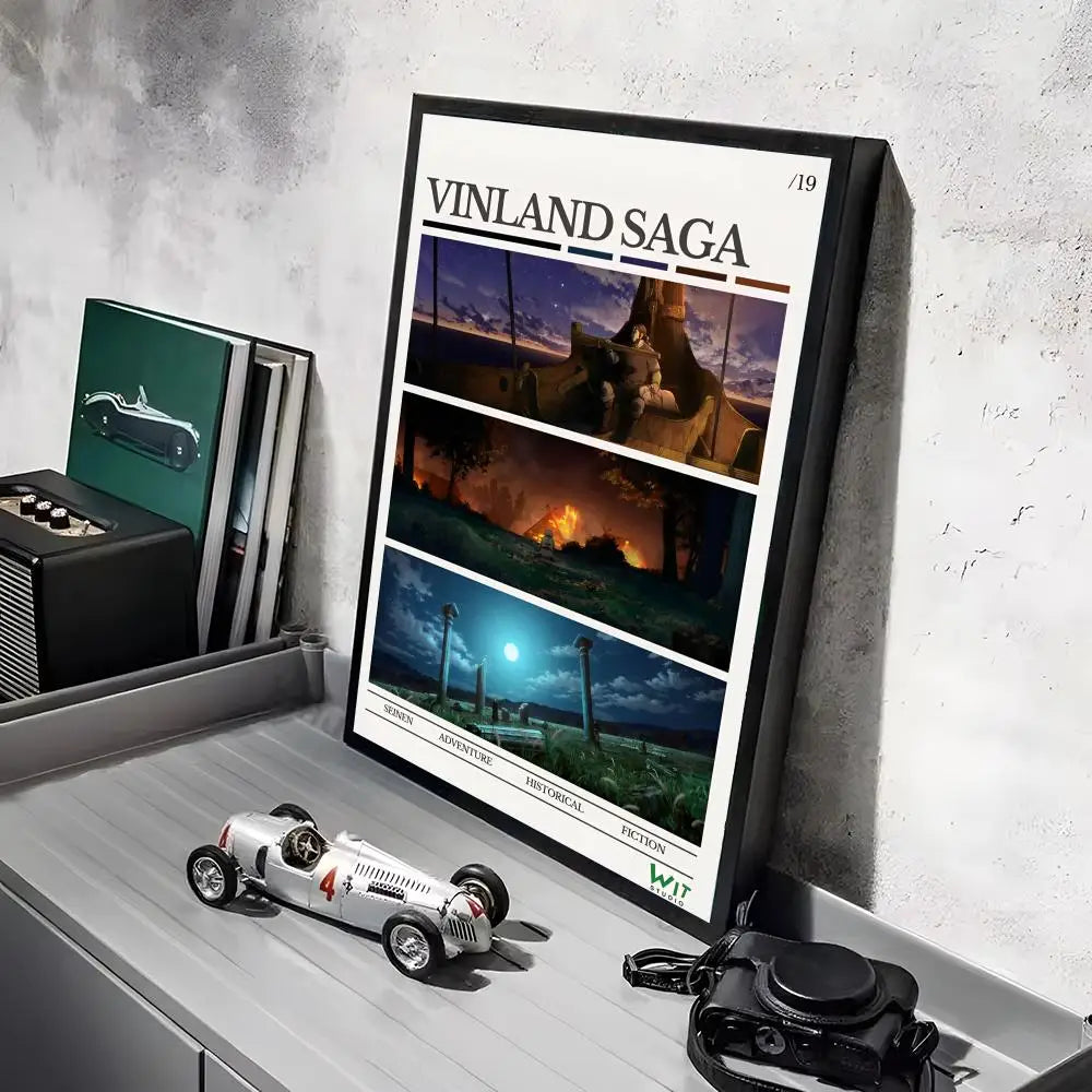 A framed poster of the Vinland Saga anime featuring a ship and landscape, displayed on a gray shelf.