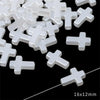 A pile of white acrylic cross shape beads for DIY jewelry making