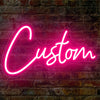 A bright pink neon sign spelling the word Custom is mounted on a textured brick wall.