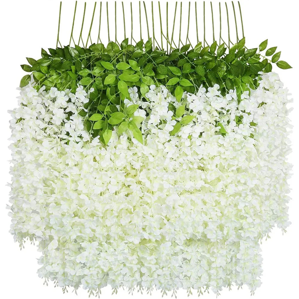 A hanging artificial wisteria flower garland featuring green leaves and white blossoms.