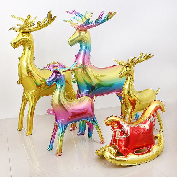 A set of two foil balloons shaped like deer in iridescent gold and rainbow colors for festive decorations.