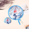 A blue portable foldable cooling handheld fan with a wave design and pink cherry blossoms is shown on a light background.