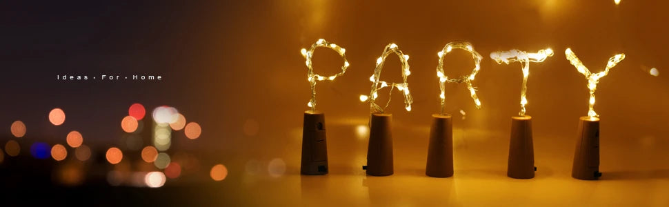 A row of ten glowing LED wine bottle cork lights set against a warm, blurred background.