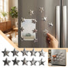 A set of ten vintage silver star magnets for photos and notes displayed on a refrigerator door.