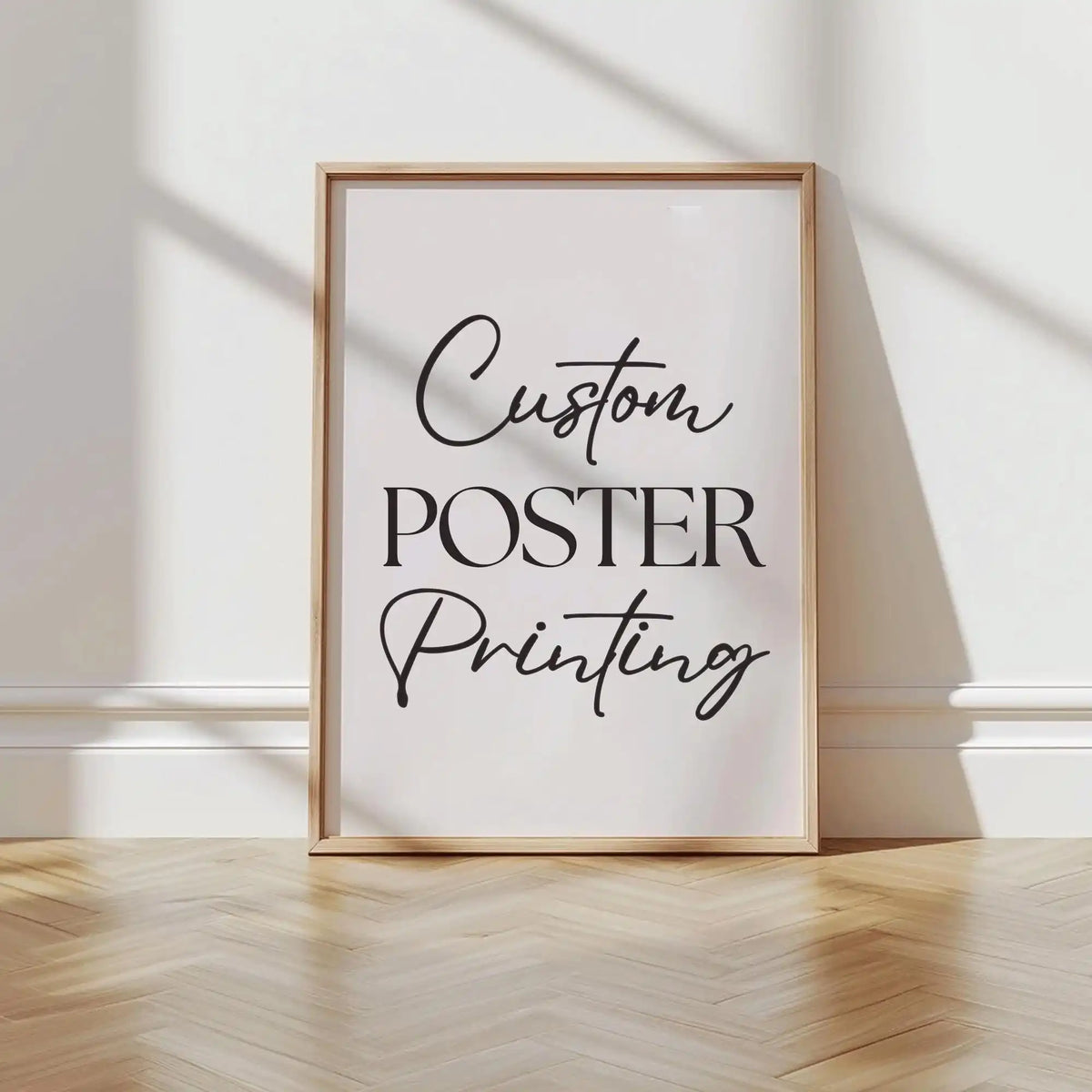 A framed poster print with black script text that reads Custom Poster Printing on a white background.