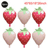 Six pink and red strawberry foil balloons for party decorations