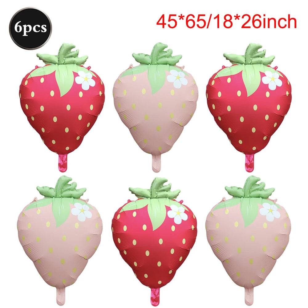 Six pink and red strawberry foil balloons for party decorations