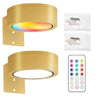 A brass-colored LED picture light fixture with a colorful light display and a remote control panel.