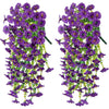 Two bunches of purple artificial morning glory flowers with green eucalyptus leaves used for hanging decor