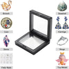 A display frame featuring various jewelry items including a brooch, coin, stone, fake nails, earrings, rings, and a toy model