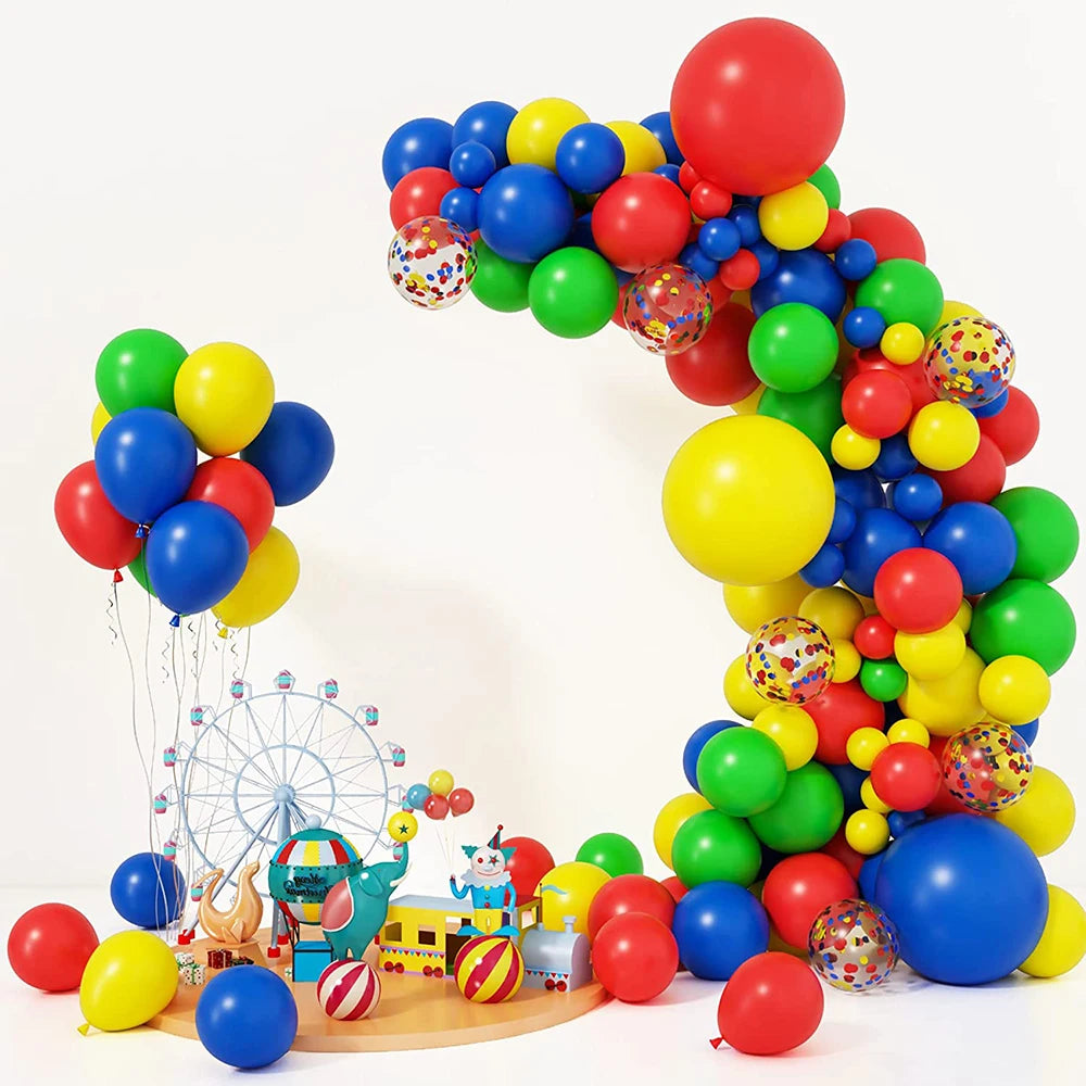 A colorful balloon garland arch featuring red, yellow, green, and blue balloons with star foil accents.