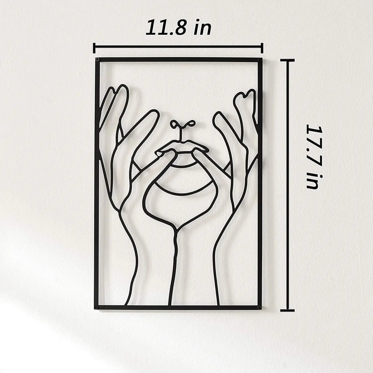 Black metal wall art featuring a silhouette of a woman's face framed by her hands